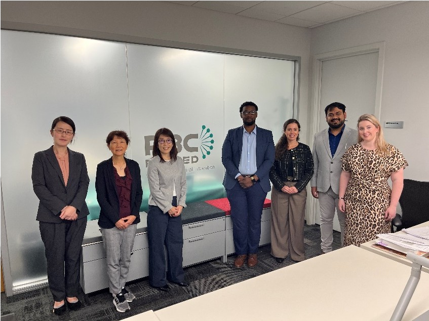 Members of PBC and Mochida standing in front of office space